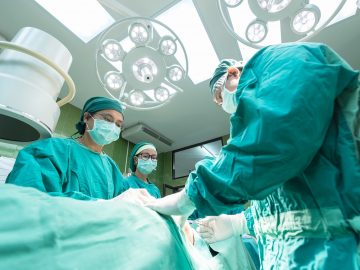 Opération de chirurgie par plusieurs médecins en blouse dans une salle d'opération